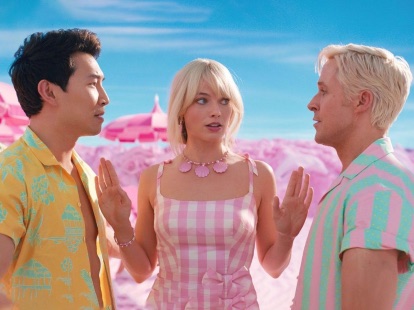 Barbie standing between two Kens